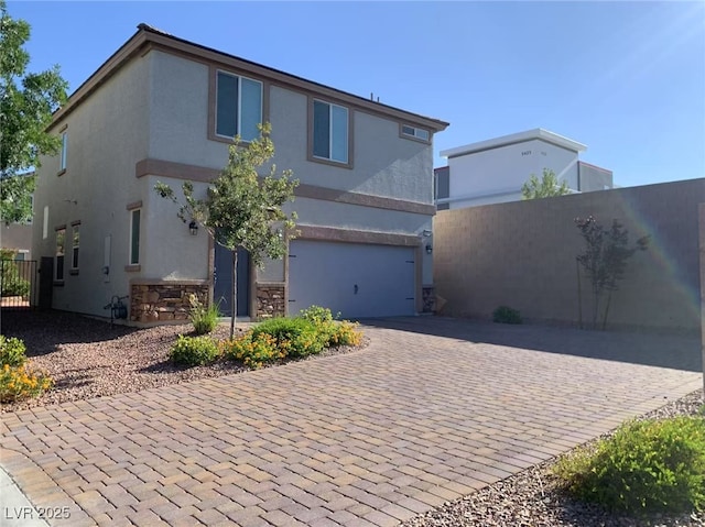 8793 Candelabra Ct, Las Vegas, NV 89148 - view of front facade featuring a garage, decorative driveway, stucco siding, and stone siding