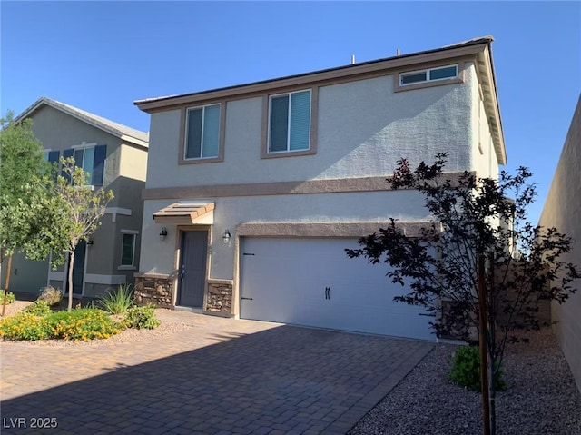 8793 Candelabra Ct, Las Vegas, NV 89148 - view of front facade featuring stucco siding, a garage, decorative driveway, and stone siding
