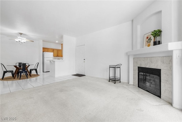 1830 N Buffalo Dr Unit 2014, Las Vegas, NV 89128 - unfurnished living room featuring a fireplace, ceiling fan, light carpet, and light tile patterned floors