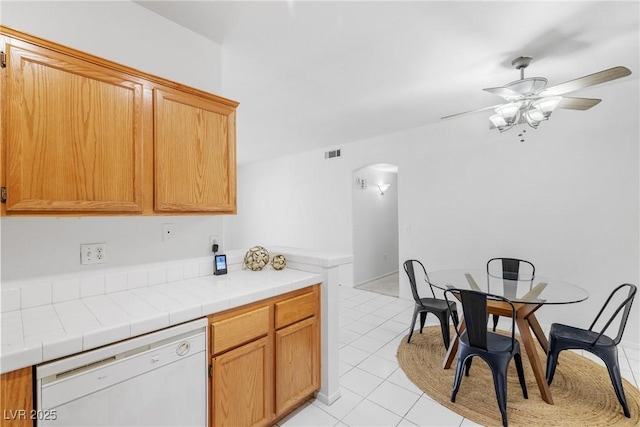 1830 N Buffalo Dr Unit 2014, Las Vegas, NV 89128 - kitchen with dishwasher, arched walkways, light tile patterned floors, ceiling fan, and tile countertops
