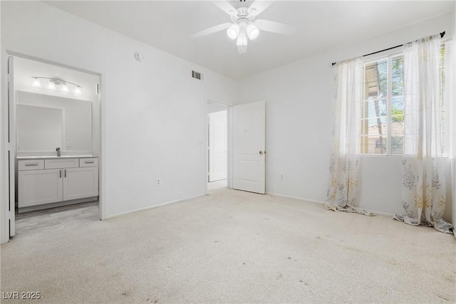 1830 N Buffalo Dr Unit 2014, Las Vegas, NV 89128 - unfurnished bedroom with light colored carpet, ensuite bathroom, baseboards, and a ceiling fan