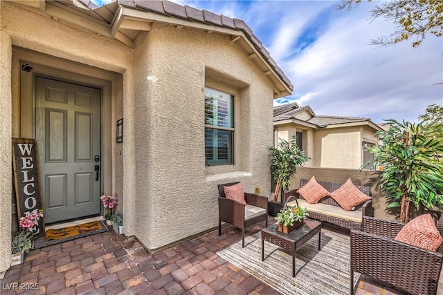 2114 Thelen Ave, North Las Vegas, NV 89086 - view of exterior entry featuring stucco siding, a patio, and an outdoor living space