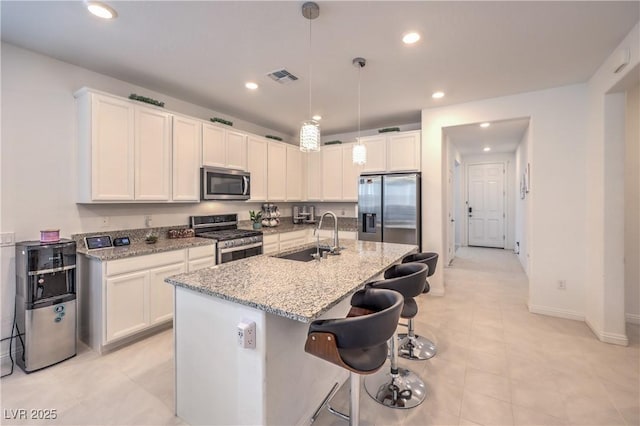 2114 Thelen Ave, North Las Vegas, NV 89086 - kitchen featuring appliances with stainless steel finishes, a sink, baseboards, recessed lighting, and light stone countertops
