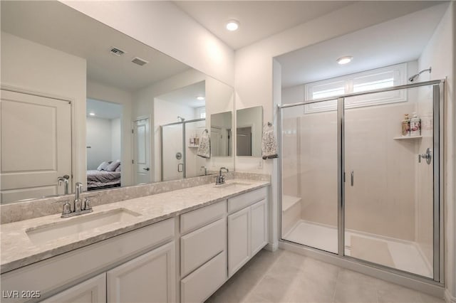 2114 Thelen Ave, North Las Vegas, NV 89086 - ensuite bathroom with a stall shower, double vanity, and tile patterned flooring