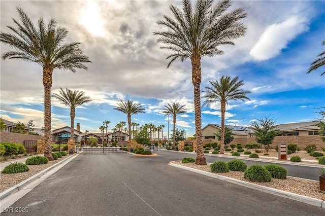 2114 Thelen Ave, North Las Vegas, NV 89086 - view of asphalt street featuring curbs, a gated entry, a gate, and a residential view