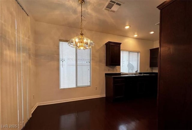 8218 Golden Flowers St, Las Vegas, NV 89139 - kitchen featuring a chandelier, dark brown cabinetry, recessed lighting, baseboards, and dark countertops