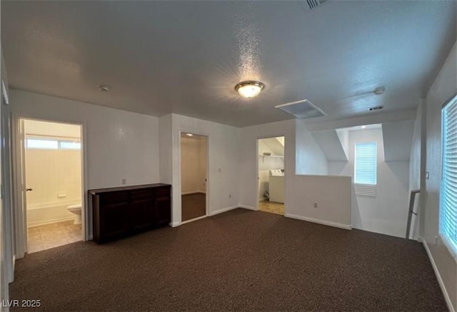 8218 Golden Flowers St, Las Vegas, NV 89139 - unfurnished living room featuring plenty of natural light, baseboards, and dark colored carpet