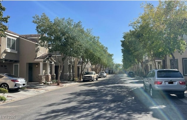 8218 Golden Flowers St, Las Vegas, NV 89139 - view of asphalt road with curbs and sidewalks