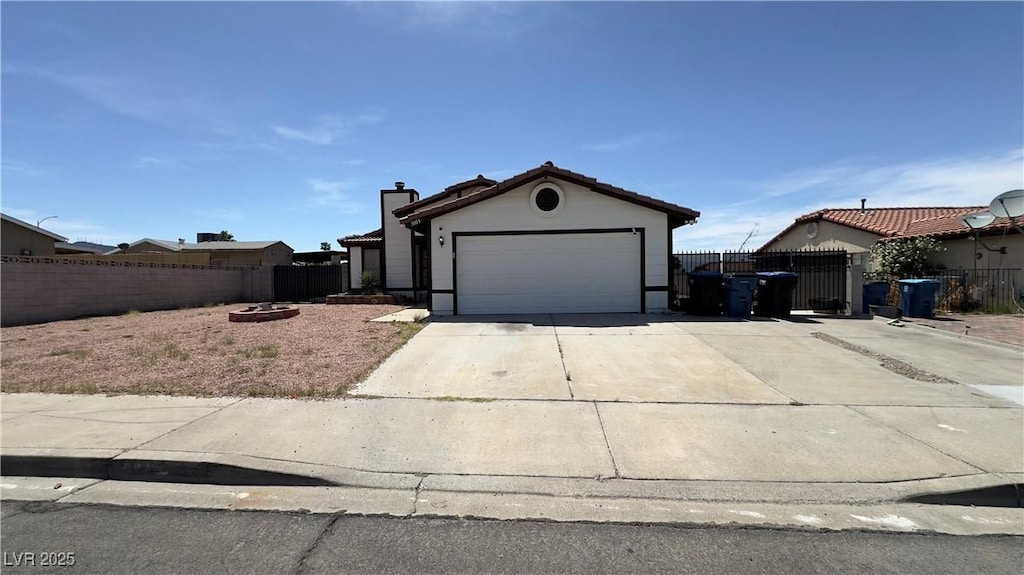 1003 Palo Verde Dr, Henderson, NV 89015 - single story home featuring driveway, a garage, a gate, and a chimney
