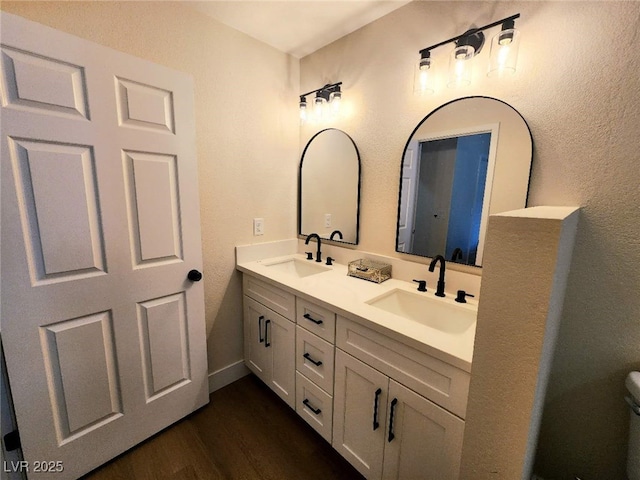 8720 Prairie Hill Dr, Las Vegas, NV 89134 - bathroom with double vanity, wood finished floors, and toilet