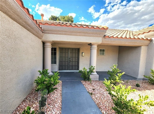 8720 Prairie Hill Dr, Las Vegas, NV 89134 - view of exterior entry featuring stucco siding and a tiled roof