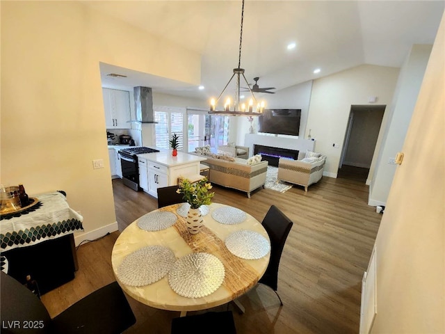 8720 Prairie Hill Dr, Las Vegas, NV 89134 - dining area with vaulted ceiling, dark wood finished floors, baseboards, a chandelier, and recessed lighting
