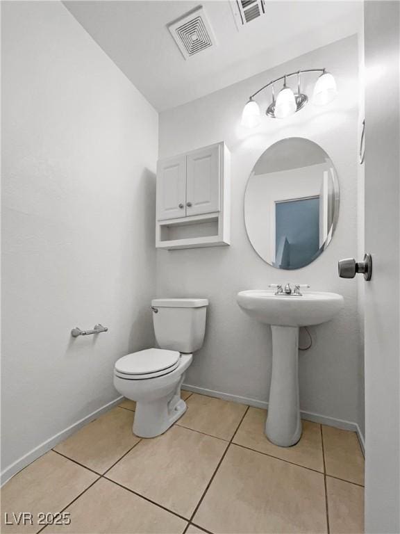 2125 Stone Well Rd, North Las Vegas, NV 89031 - bathroom with tile patterned floors, toilet, and baseboards