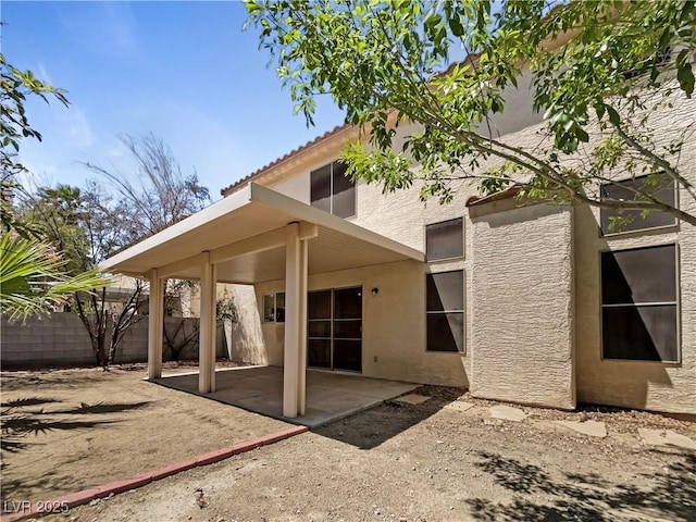 2125 Stone Well Rd, North Las Vegas, NV 89031 - rear view of house featuring stucco siding, a patio area, and a tiled roof