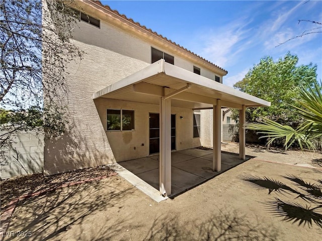 2125 Stone Well Rd, North Las Vegas, NV 89031 - rear view of house with stucco siding, a patio, a tiled roof, and a balcony
