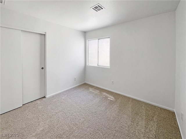2125 Stone Well Rd, North Las Vegas, NV 89031 - unfurnished bedroom with a closet, carpet, and baseboards