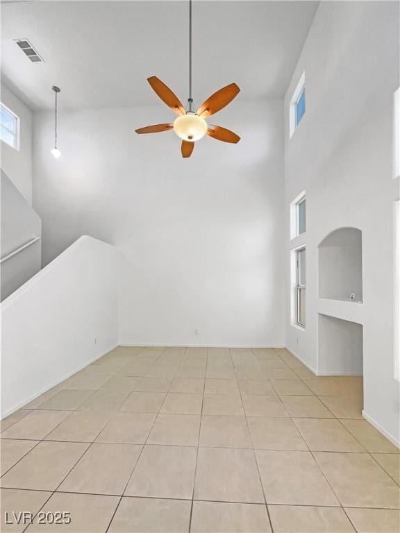 2125 Stone Well Rd, North Las Vegas, NV 89031 - spare room featuring ceiling fan, light tile patterned floors, and a high ceiling