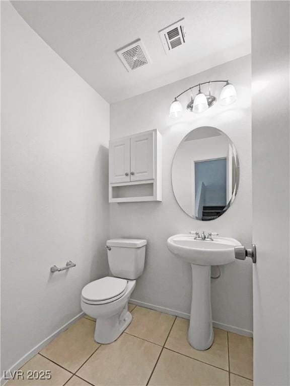 2125 Stone Well Rd, North Las Vegas, NV 89031 - half bath featuring tile patterned floors, baseboards, and toilet