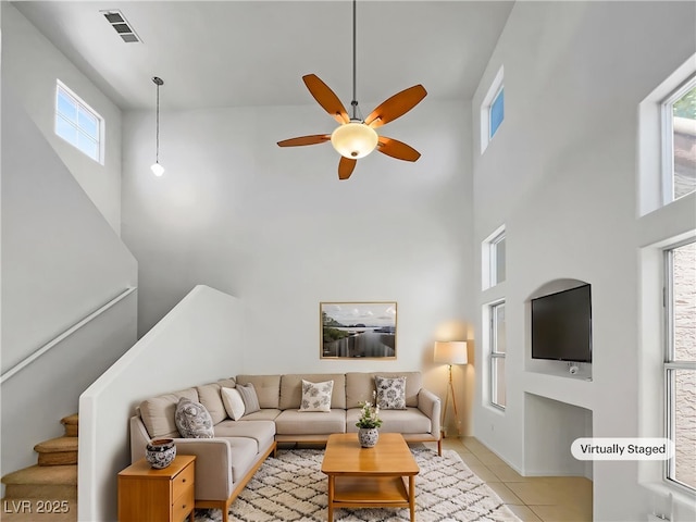2125 Stone Well Rd, North Las Vegas, NV 89031 - living area with a high ceiling, ceiling fan, light tile patterned flooring, and stairway