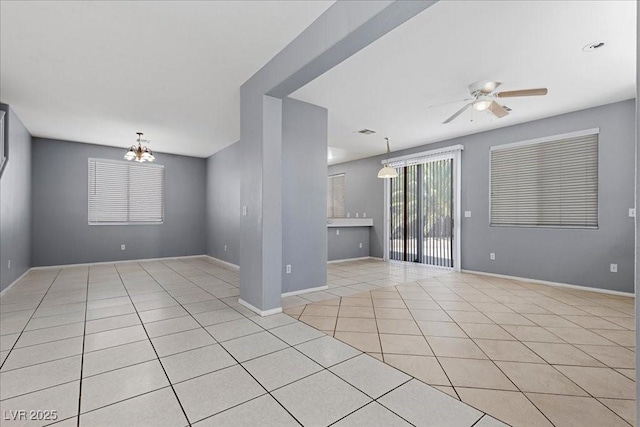 180 Duck Hollow Ave, Las Vegas, NV 89148 - spare room with ceiling fan, light tile patterned flooring, a chandelier, and baseboards