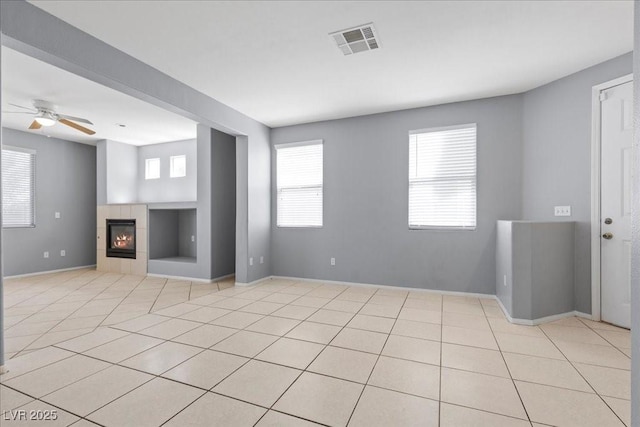 180 Duck Hollow Ave, Las Vegas, NV 89148 - unfurnished living room with built in features, light tile patterned flooring, a fireplace, a ceiling fan, and baseboards