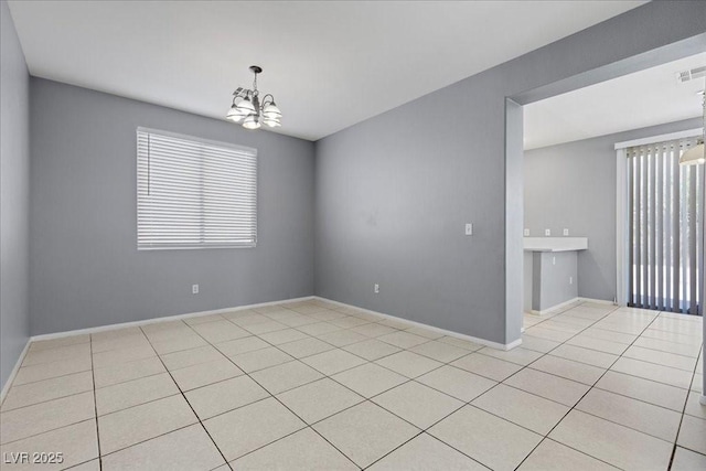 180 Duck Hollow Ave, Las Vegas, NV 89148 - empty room with a chandelier, light tile patterned floors, and baseboards