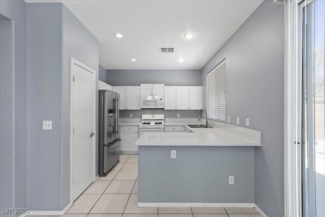 180 Duck Hollow Ave, Las Vegas, NV 89148 - kitchen featuring white appliances, a sink, a peninsula, white cabinets, and light countertops