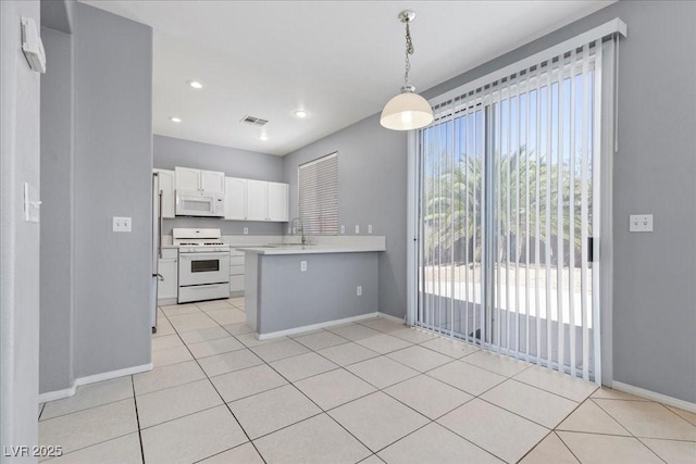 180 Duck Hollow Ave, Las Vegas, NV 89148 - kitchen featuring white appliances, baseboards, light countertops, white cabinets, and a peninsula