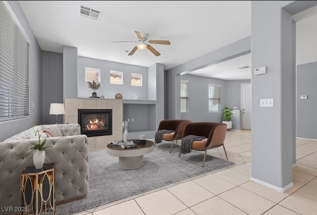 180 Duck Hollow Ave, Las Vegas, NV 89148 - living room with light tile patterned flooring, ceiling fan, a tile fireplace, built in shelves, and baseboards