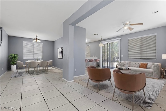 180 Duck Hollow Ave, Las Vegas, NV 89148 - living area featuring light tile patterned flooring, ceiling fan, a chandelier, and baseboards