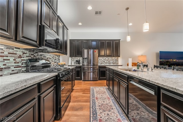 715 Orange Plume Walk, Henderson, NV 89011 - kitchen featuring black appliances, a sink, pendant lighting, light stone countertops, and recessed lighting