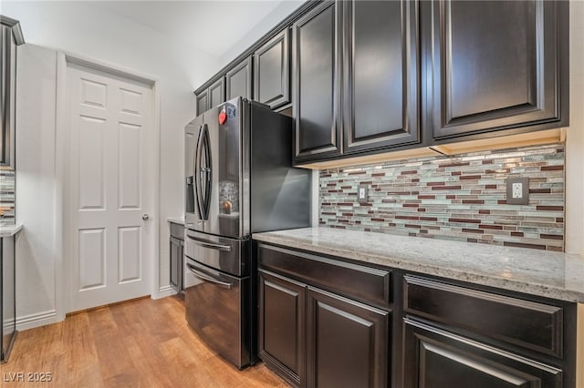 715 Orange Plume Walk, Henderson, NV 89011 - kitchen featuring stainless steel fridge with ice dispenser, light wood finished floors, tasteful backsplash, and light stone countertops