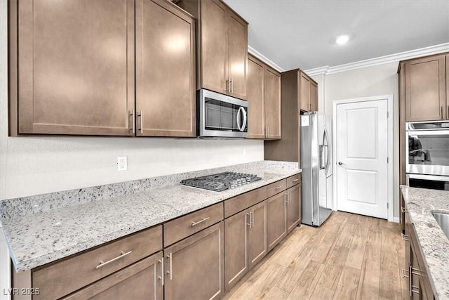 4510 Rubious Ave, North Las Vegas, NV 89084 - kitchen with stainless steel appliances, light wood finished floors, crown molding, light stone counters, and recessed lighting