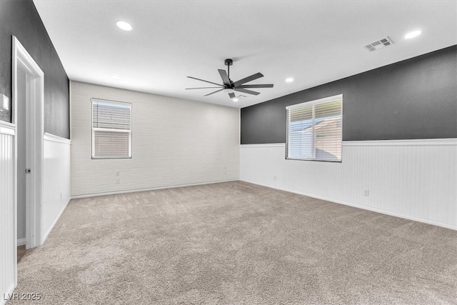4510 Rubious Ave, North Las Vegas, NV 89084 - spare room with a wainscoted wall, ceiling fan, carpet, recessed lighting, and healthy amount of natural light