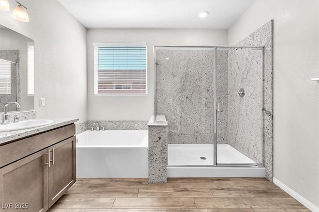 4510 Rubious Ave, North Las Vegas, NV 89084 - full bathroom with vanity, a garden tub, a stall shower, and wood finished floors
