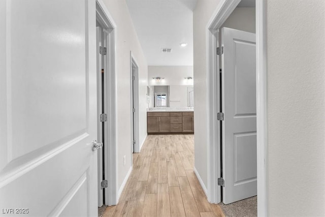 4510 Rubious Ave, North Las Vegas, NV 89084 - corridor with light wood-style floors and baseboards