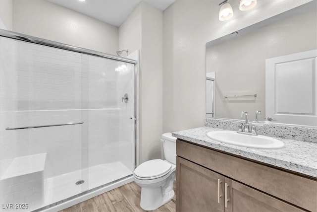 4510 Rubious Ave, North Las Vegas, NV 89084 - bathroom featuring toilet, wood finished floors, a stall shower, and vanity