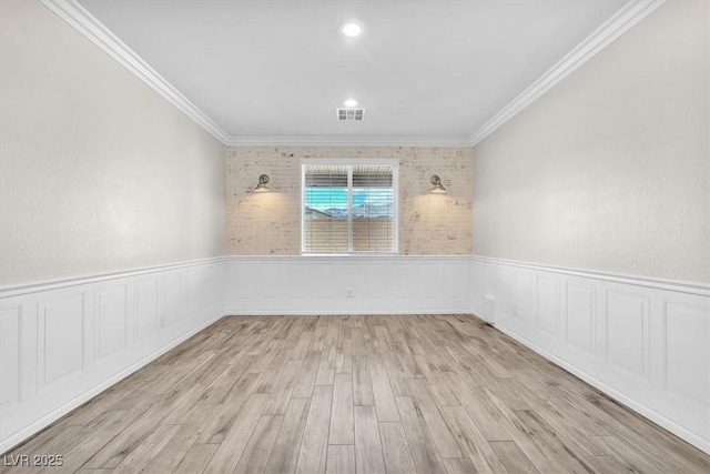 4510 Rubious Ave, North Las Vegas, NV 89084 - empty room featuring crown molding, a wainscoted wall, and wood finished floors