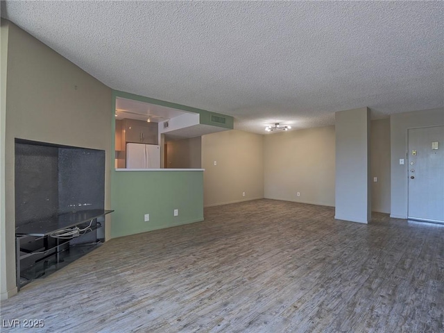 725 N Royal Crest Cir Unit 228, Las Vegas, NV 89169 - unfurnished living room with wood finished floors and a textured ceiling
