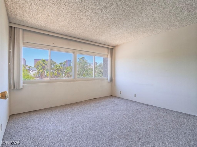 725 N Royal Crest Cir Unit 228, Las Vegas, NV 89169 - unfurnished room featuring carpet and a textured ceiling