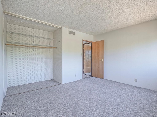 725 N Royal Crest Cir Unit 228, Las Vegas, NV 89169 - unfurnished bedroom featuring carpet and a textured ceiling