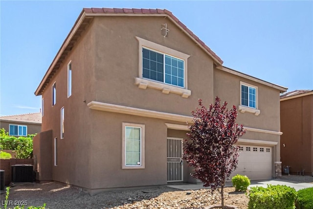 9173 Weeping Hollow Ave, Las Vegas, NV 89178 - view of front facade with central AC unit, an attached garage, and stucco siding