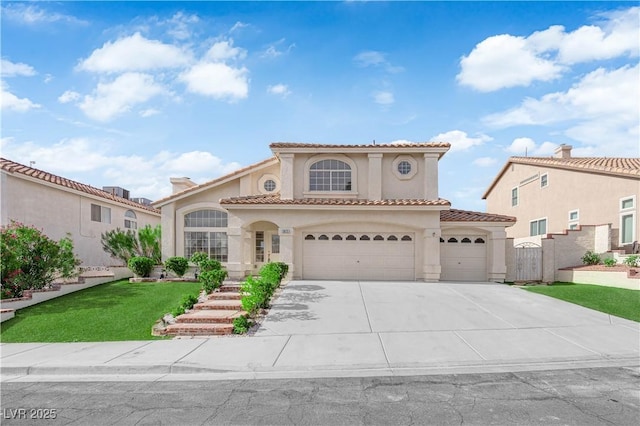 1611 Buffalo Trail Dr, Henderson, NV 89014 - mediterranean / spanish home with stucco siding, concrete driveway, a tile roof, and an attached garage
