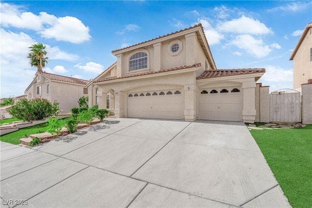 1611 Buffalo Trail Dr, Henderson, NV 89014 - mediterranean / spanish-style home featuring concrete driveway, stucco siding, a tiled roof, a garage, and a front yard