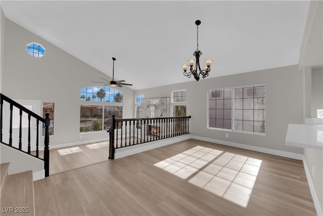 1611 Buffalo Trail Dr, Henderson, NV 89014 - unfurnished living room with high vaulted ceiling, wood finished floors, plenty of natural light, baseboards, and a chandelier