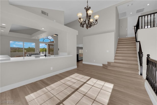 1611 Buffalo Trail Dr, Henderson, NV 89014 - entrance foyer with stairway, light wood-type flooring, a chandelier, baseboards, and a high ceiling