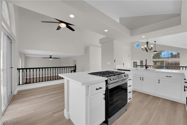 1611 Buffalo Trail Dr, Henderson, NV 89014 - kitchen with gas range, ceiling fan, a sink, recessed lighting, and light wood-type flooring