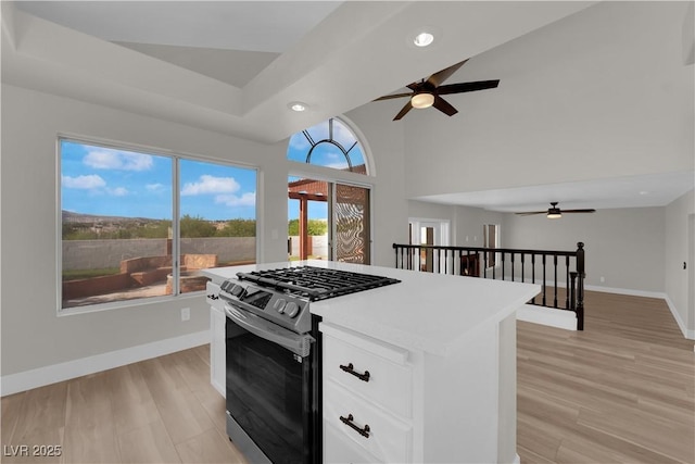 1611 Buffalo Trail Dr, Henderson, NV 89014 - kitchen featuring gas range, a ceiling fan, baseboards, recessed lighting, and white cabinetry