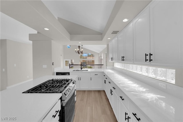1611 Buffalo Trail Dr, Henderson, NV 89014 - kitchen with gas stove, recessed lighting, a chandelier, light countertops, and white cabinets