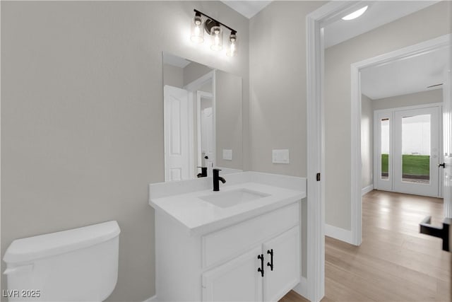 1611 Buffalo Trail Dr, Henderson, NV 89014 - half bath with toilet, vanity, wood finished floors, and baseboards
